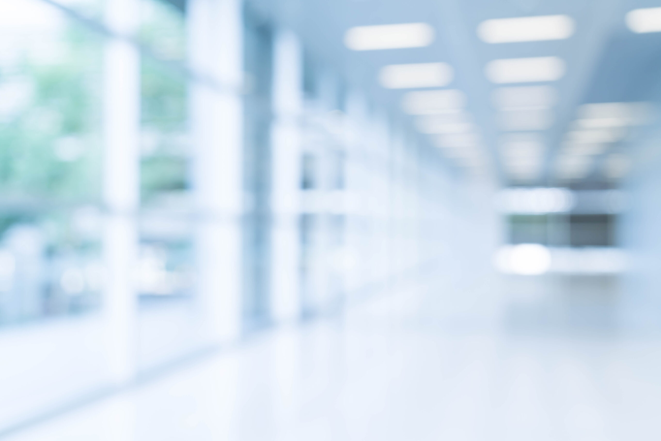 Blurred abstract background interior view looking out toward to empty office lobby and entrance doors and glass curtain wall with frame - blue white balance processing style